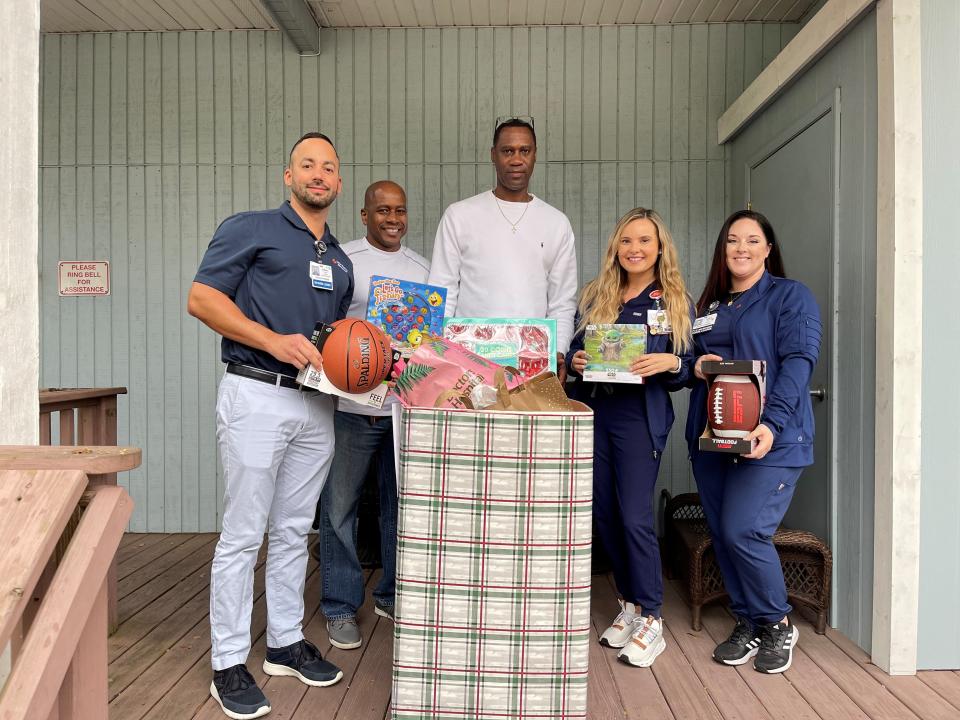 Nurses from HCA Florida Sarasota Doctors Hospital bring donated gifts to staff members at the Safe Children Coalition’s youth shelter. Jeffery Vazquez, left, Alan Abernathy, Charles Harris, Stephanie Kent and Leena Cathcart.