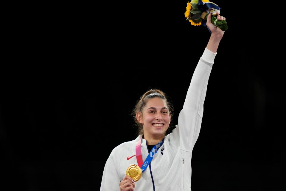 Anastasija Zolotic celebrates on the podium after winning gold in the women's under-57 kilogram division during the Tokyo 2020 Olympic Summer Games at Makuhari Messe Hall A.