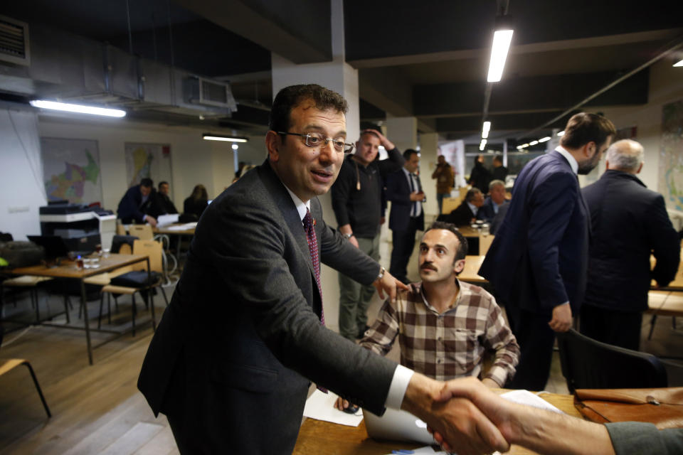Ekrem Imamoglu, the opposition, Republican People's Party's (CHP) mayoral candidate in Istanbul, shakes hands with staff of his campaign in Istanbul, Thursday, April 4, 2019. Imamoglu said he's confident that the result of a recount of votes in the city will confirm his victory and has renewed an appeal to Turkey's President Recep Tayyip Erdogan to help end the standoff. Imamoglu won the tight race for Istanbul in Sunday's local elections in a major upset for Erdogan, who rose to power as the mayor of the city of 15 million and has said that whoever wins Istanbul wins to whole of Turkey. (AP Photo/Lefteris Pitarakis)