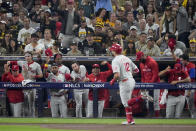 The Philadelphia Phillies celebrate a home run by Kyle Schwarber during the sixth inning in Game 1 of the baseball NL Championship Series between the San Diego Padres and the Philadelphia Phillies on Tuesday, Oct. 18, 2022, in San Diego. (AP Photo/Ashley Landis)
