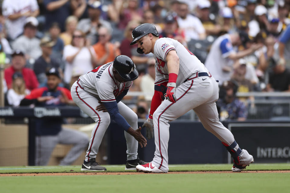 Atlanta Braves' Joc Pederson, right, is congratulated by third base coach Ron Washington as he rounds the bag after hitting a solo home run in the second inning of a baseball game against the San Diego Padres, Sunday, Sept. 26, 2021, in San Diego. (AP Photo/Derrick Tuskan)