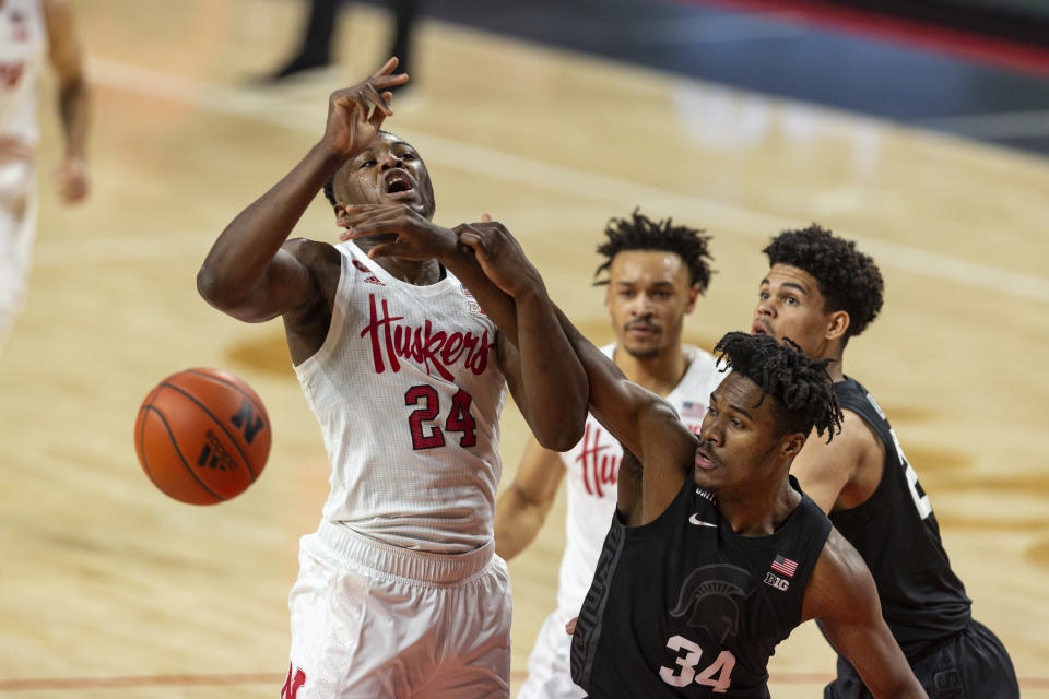 Nebraska forward Yvan Ouedraogo (24) receives a foul from Michigan State forward Julius Marble II (34) in the first half during an NCAA college basketball game on Saturday, Jan., 2, 2021, in Lincoln, Neb. (AP Photo/John Peterson)