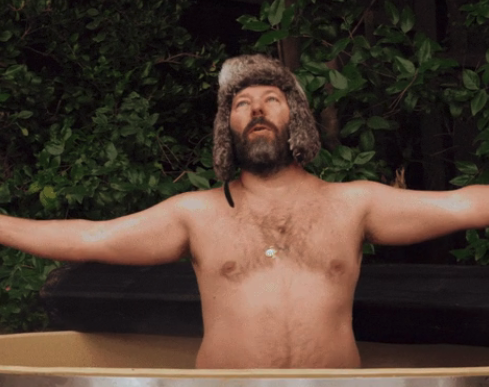 A shirtless man in a hot tub