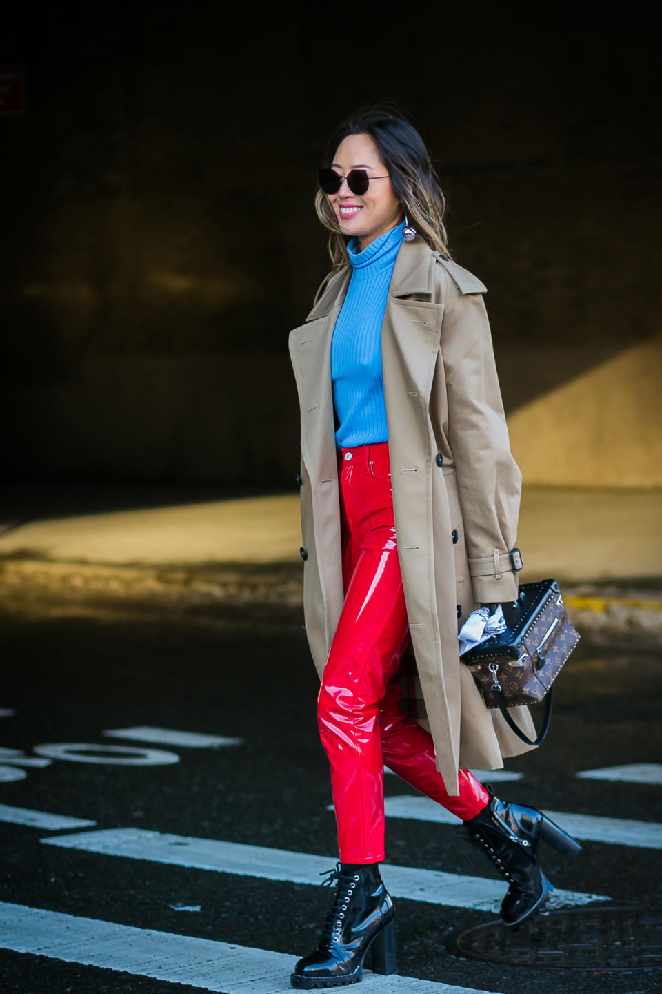 Aimee Song attends New York Fashion Week in vibrant red and blue.
