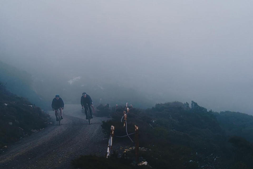 gravel bike riders on a hazy mountain road