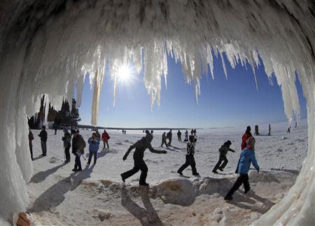 Sightseers look at icicles at the mouth of a sea cave of the Apostle Islands National Lakeshore of Lake Superior near Cornucopia, Wisconsin February 14, 2014. REUTERS/Eric Miller