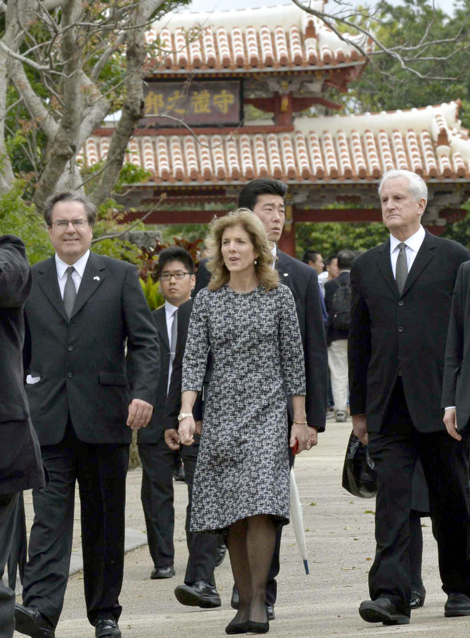 U.S. Ambassador to Japan Caroline Kennedy, right, leaves Shuri castle in Naha, Okinawa Wednesday, Feb. 12, 2014. Kennedy has made her first visit to the southernmost island of Okinawa, hoping to get support for a controversial plan to relocate a U.S. military base. (AP Photo/Kyodo News) JAPAN OUT, MANDATORY CREDIT