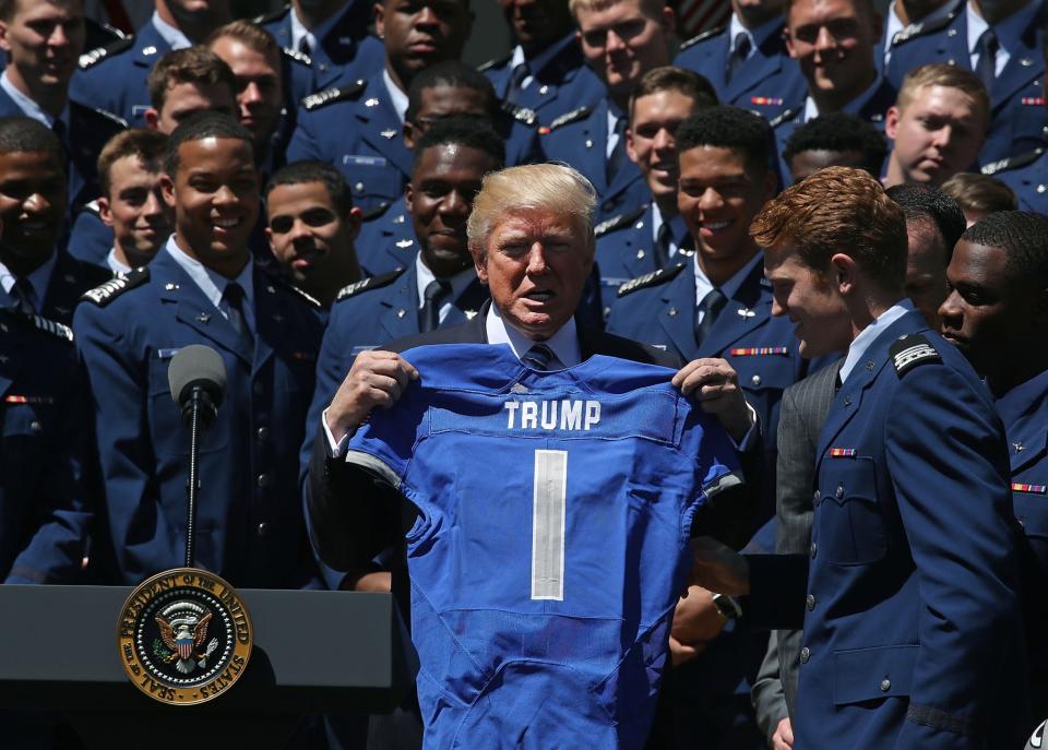 President Donald Trump gets a jersey from Air Force. (Getty)