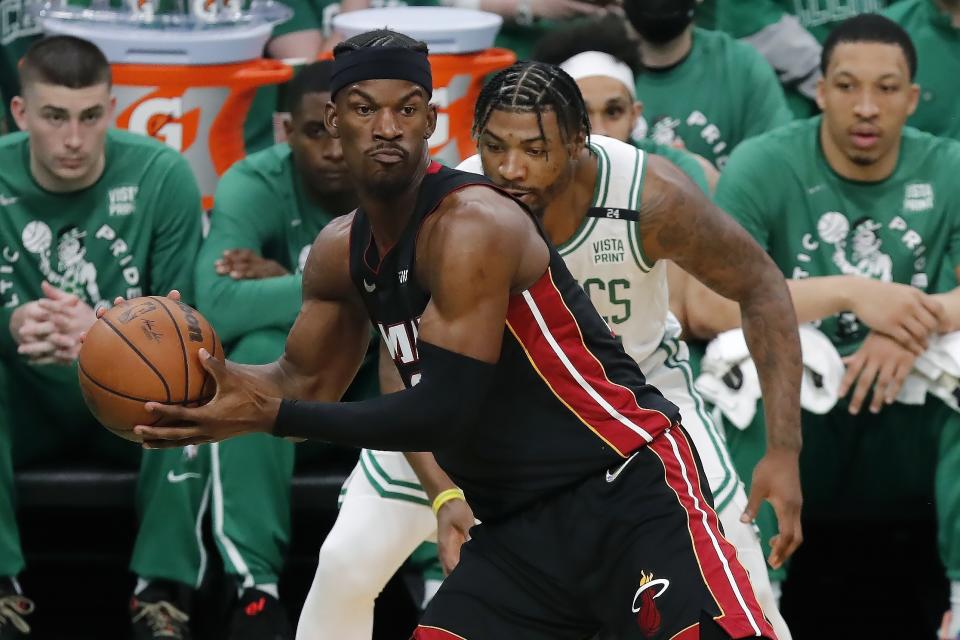 Miami Heat's Jimmy Butler (22) intercepts a pass intended for Boston Celtics' Marcus Smart, behind, during the first half of Game 3 of the NBA basketball playoffs Eastern Conference finals Saturday, May 21, 2022, in Boston. (AP Photo/Michael Dwyer)