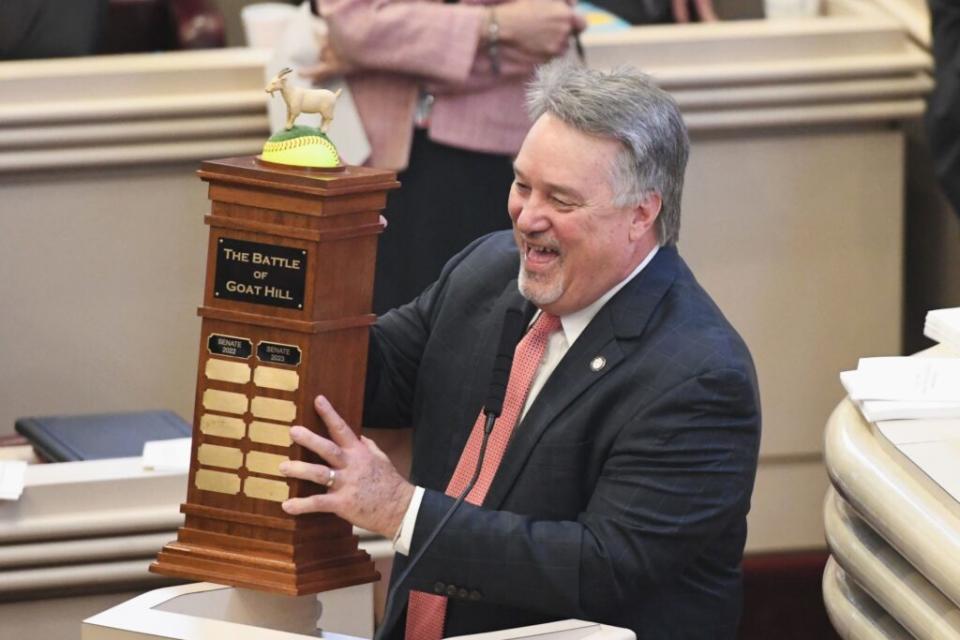 A man displaying a trophy