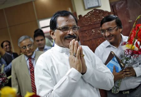 Shripad Naik, India's new minister in charge of the department of Ayurveda, Yoga and Naturopathy, Unani, Siddha and Homeopathy (AYUSH), greets the media as he arrives to take charge of his office in New Delhi November 11, 2014. REUTERS/Anindito Mukherjee