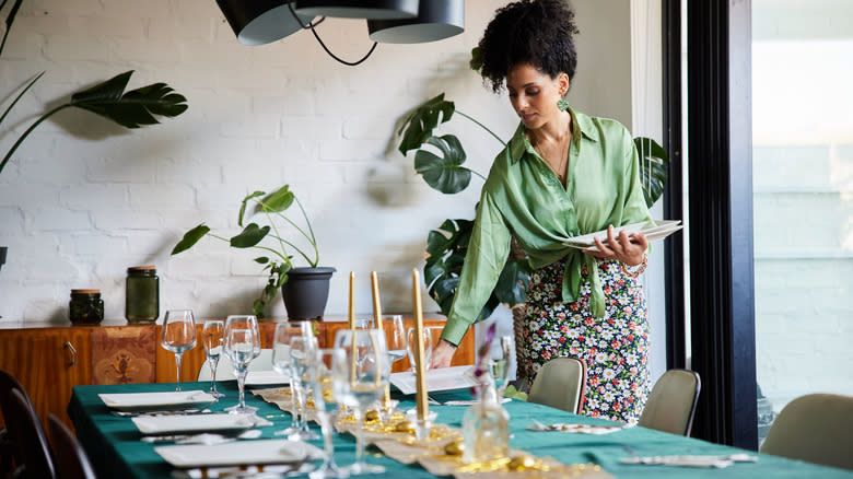 Person setting a dinner table