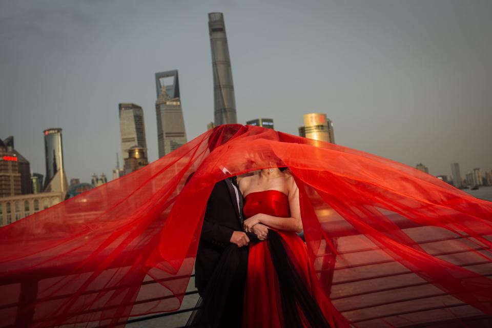 Chinese couples used to be satisfied with a single black-and-white photograph taken during their wedding as a memento of their special day. But times have changed dramatically, and wedding photographs, especially pre-wedding photo sessions, have become big business in China.In the main tourist spots in different cities across China, it’s easy to see couples having their pre-wedding picture shoots, which have become the must-have for every Chinese couple before their marriage.Unlike western weddings, where usually couples have their photos taken on the day, for Chinese people it is popular to have day-long photo sessions way before the actual wedding. Sometimes it can be half a year or even a year in advance of the ceremony. To make these pre-wedding photos as unique as possible, lots of couples will select unusual spots as a backdrop, such as a fake field with deer and a sky full of stars, or in an interior scene made to look like one of the largest religious Cambodian monuments, Angkor Wat; all of these spots can be found in photo studios. Some couples even choose other countries for their pre-wedding sessions.Often for their photo shoots couples go for traditionally romantic cities such as Paris. Those who can’t afford such a trip can have their photo taken in front of Chinese replicas of the world’s main tourist sights. Other couples prefer more traditional outdoor locations, like Beijing’s Hutong neighbourhood, or to be surrounded by nature like in Dali, where lots of couples do their pre-wedding photography next to Erhai Lake.These sessions can range in price from a few hundred up to thousands of dollars, with companies providing clients with everything from outfits to make-up and transportation.Brides typically have at least three dress changes per shoot. Inspired by the western style, many choose a flowing white wedding dress, a Chinese-style red gown, and something more modern. The shoots are just one part of a booming industry in China.A wedding for most newly married couples can run from 50,000 yuan (£6,000) to 200,000 yuan, with larger amounts not uncommon in big cities like Beijing or Shanghai.China’s wedding industry was valued at 1.46 trillion yuan in 2017, and it is expected to grow to 3 trillion yuan by 2021.