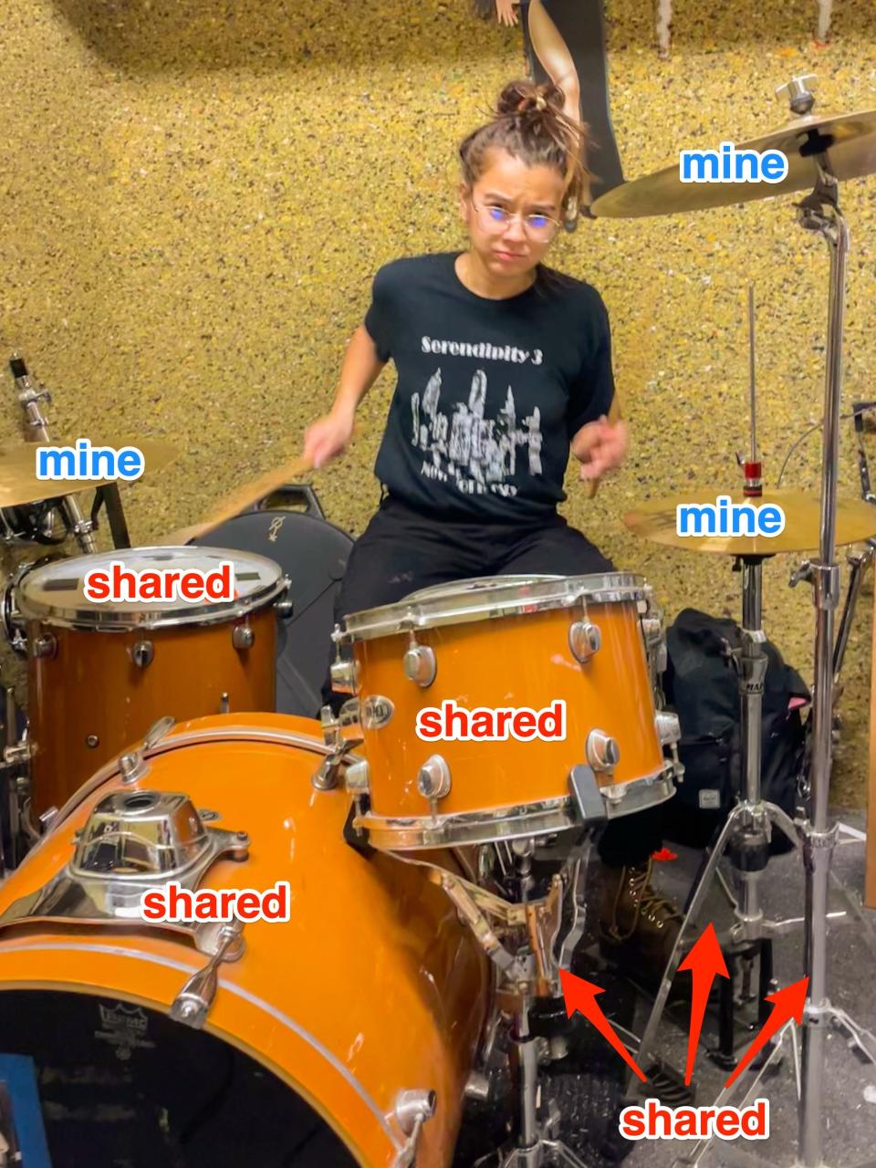 The author plays drums in a practice room