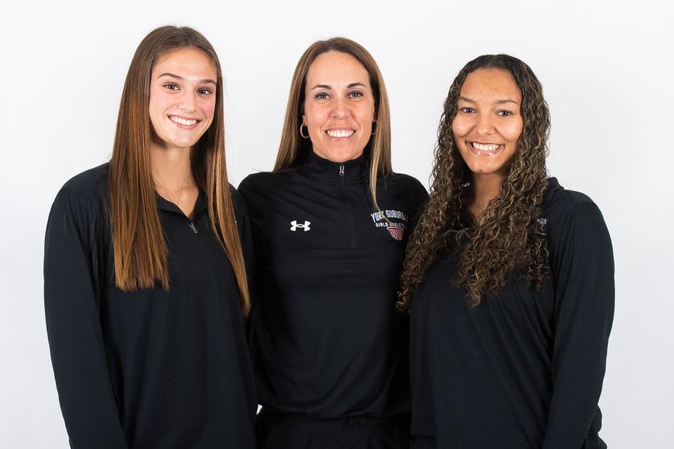 York Suburban basketball players Lydia Powers (left) and Janay Rissmiller (right) pose for a photo with head coach Jess Weaver during YAIAA winter sports media days Wednesday, November 8, 2023, in York.