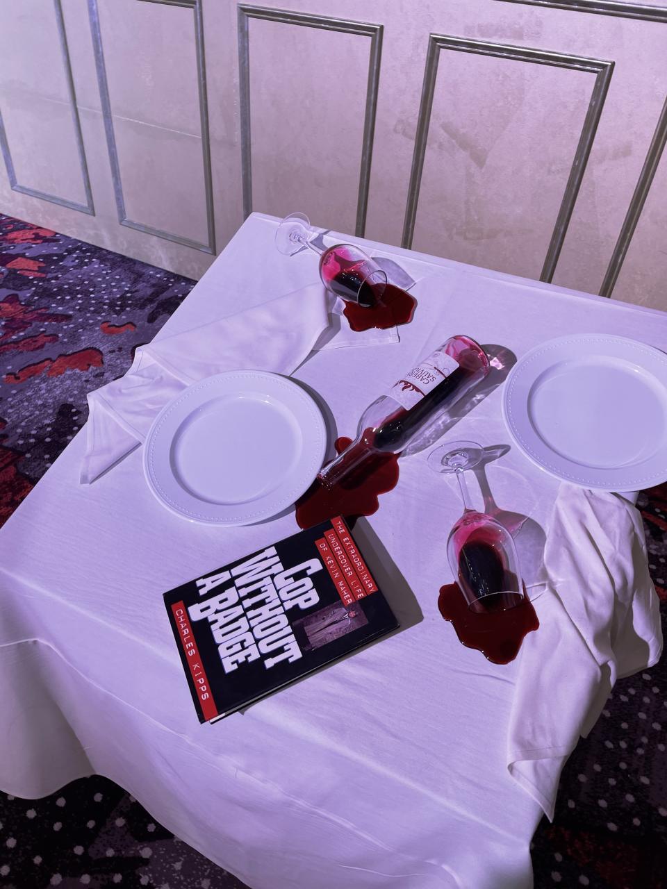 A white table cloth on a table displaying Danielle's "A cop without a badge" book