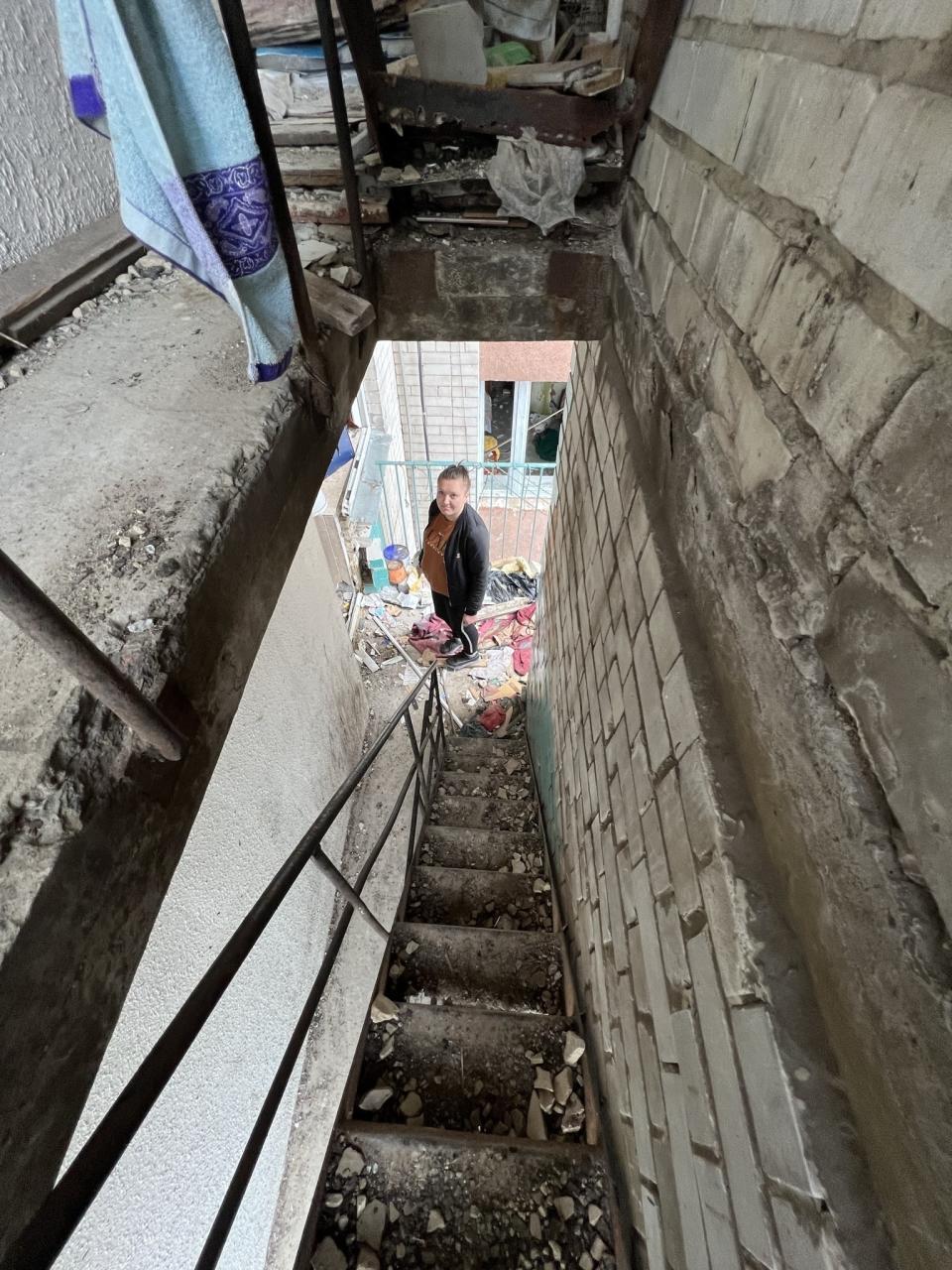 Kateryna Prykhodko stands for a portrait in Chernihiv, Ukraine, on April 22, 2022, in the stairwell of the building where she dug the bodies of her sister and brother-in-law, and their three children, including three-year-old twins, out of the rubble of their apartment with her own bare hands, after a Russian attack. “I hate Russia!” she says. “If Russians came to you, if you felt what I had felt, how would you feel? To lose everything in one moment! The whole family! Why did you come to our Ukraine? Why!? We did not want the war!” (AP Photo/Erika Kinetz)