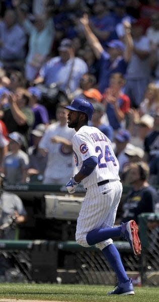 Chicago Cubs' Dexter Fowler watches his solo home run during the first inning of a baseball game against the Atlanta Braves on Sunday, Aug. 23, 2015, in Chicago. (AP Photo/Paul Beaty)
