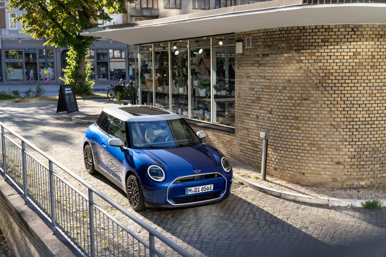 2024 Mini Cooper SE Electric in blue parked in front of building