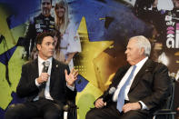 Jimmie Johnson, left, looks to team owner Rick Hendrick as he answers a reporter's question during his NASCAR retirement announcement at Hendrick Motorsports near Charlotte, N.C., Thursday, Nov. 21, 2019. (AP Photo/Bob Leverone)