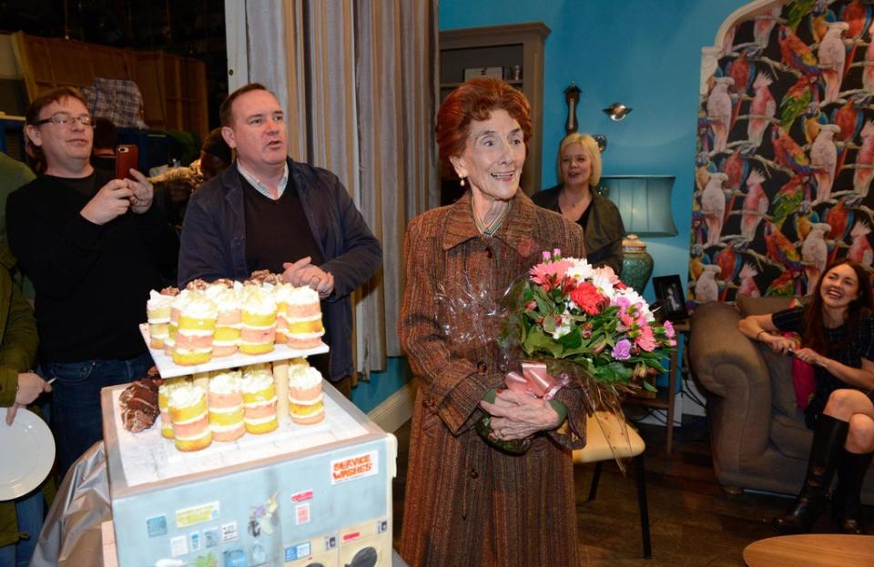 Adam Woodyatt, Sean O’Connor, Sharon Batten and Lacey Turner surprise June Brown with cake and flowers to help her celebrate her 90th birthday on the set of EastEnders (Kieron McCarron/PA) (PA Media)