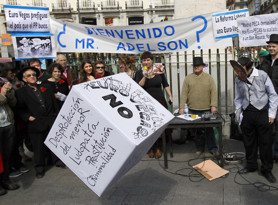 People gathered in a protest against the Eurovegas project in Madrid, Spain, Saturday, March 17, 2012. Poster reads "Welcome Mister Adelson?", "Eurovegas no!", "Labor reform is Eurovegas", "Eurovegas shows the country what the Popular Party wants", "Vulnerability of the children", "Prostitution", "Gambling addiction" and "Criminality". Eurovegas is a U.S. billionaire's proposal that promises to build six casinos, 12 hotels and create jobs in a country on the brink of its second recession in four years and an unemployment rate near 23%. Madrid has been selected by Sheldon Adelson, 78, and his company Las Vegas Sands to be the site of Eurovegas, a project which protesters say would cost Spain more in grants, concessions and problems than it would yield benefits. (AP Photo/Andres Kudacki)