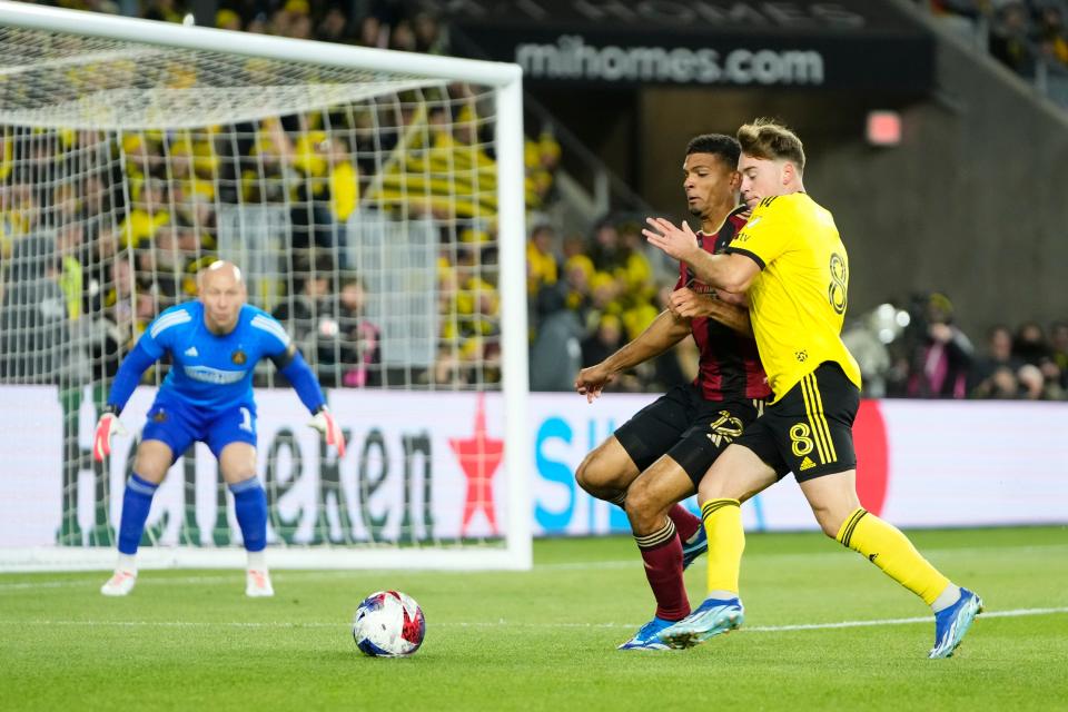 Nov 1, 2023; Columbus, Ohio, USA; Columbus Crew midfielder Aidan Morris (8) fights for the ball with Atlanta United defender Miles Robinson (12) during the first half of the first round MLS Cup Playoffs matchup at Lower.com Field.