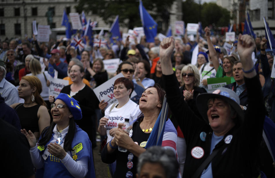 Remain supporters wave EU and Union flags as they demonstrate on Parliament Square in London, Wednesday, Sept. 4, 2019. With Britain's prime minister weakened by a major defeat in Parliament, defiant lawmakers were moving Wednesday to bar Boris Johnson from pursuing a "no-deal" departure from the European Union. (AP Photo/Matt Dunham)