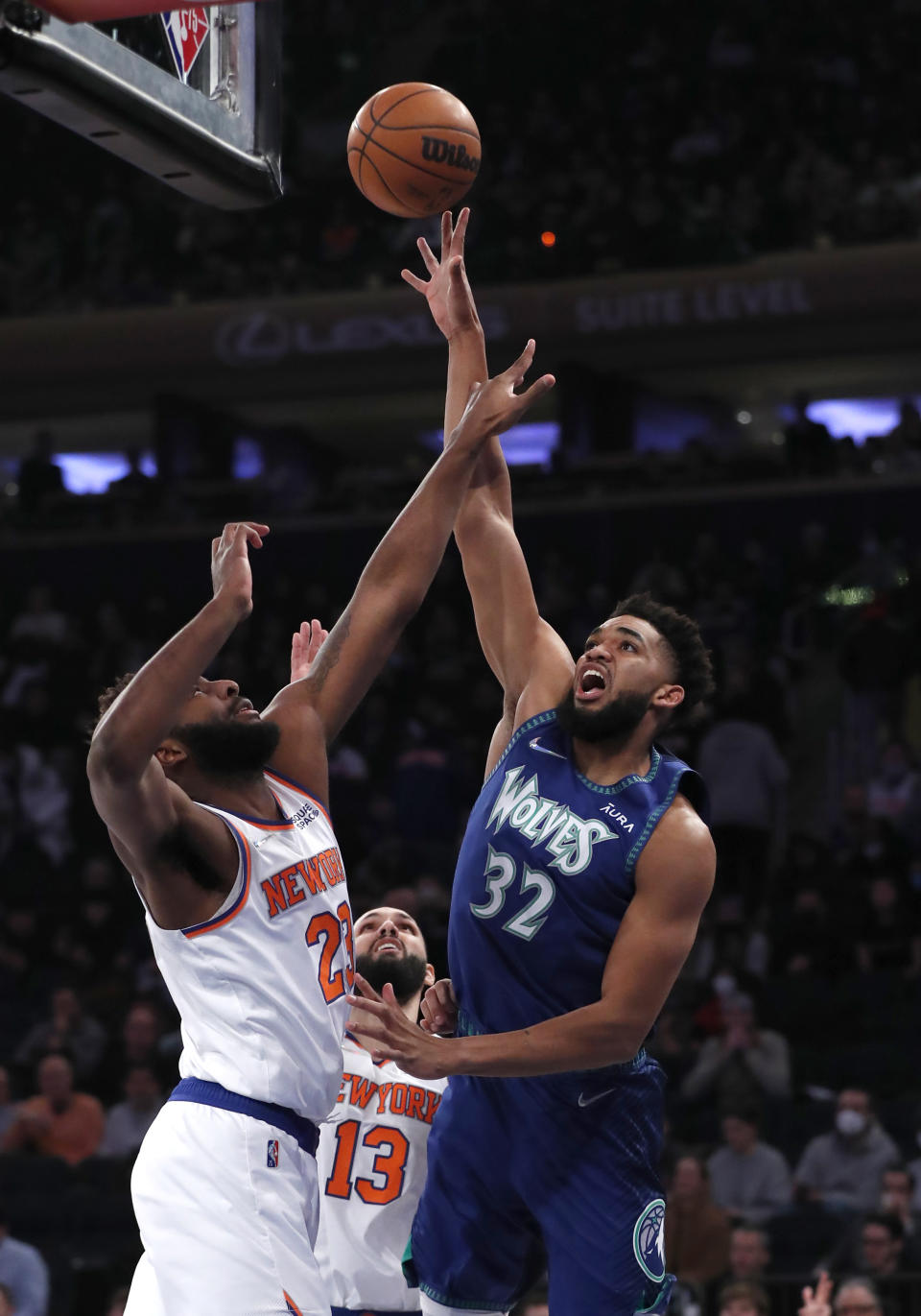 Minnesota Timberwolves center Karl-Anthony Towns (32) shoots over New York Knicks center Mitchell Robinson (23) during the first half of an NBA basketball game, Tuesday, Jan. 18, 2022 in New York. (AP Photo/Noah K. Murray)