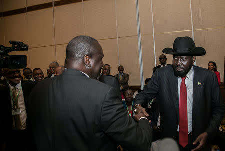 South Sudan President Salva Kiir (R) greets South Sudan Rebel leader Riek Machar during the 32nd Extra-Ordinary Summit of IGAD Assembly of Heads of State and Government in Addis Ababa, Ethiopia June 21, 2018. Presidential Press Service/Handout via REUTERS