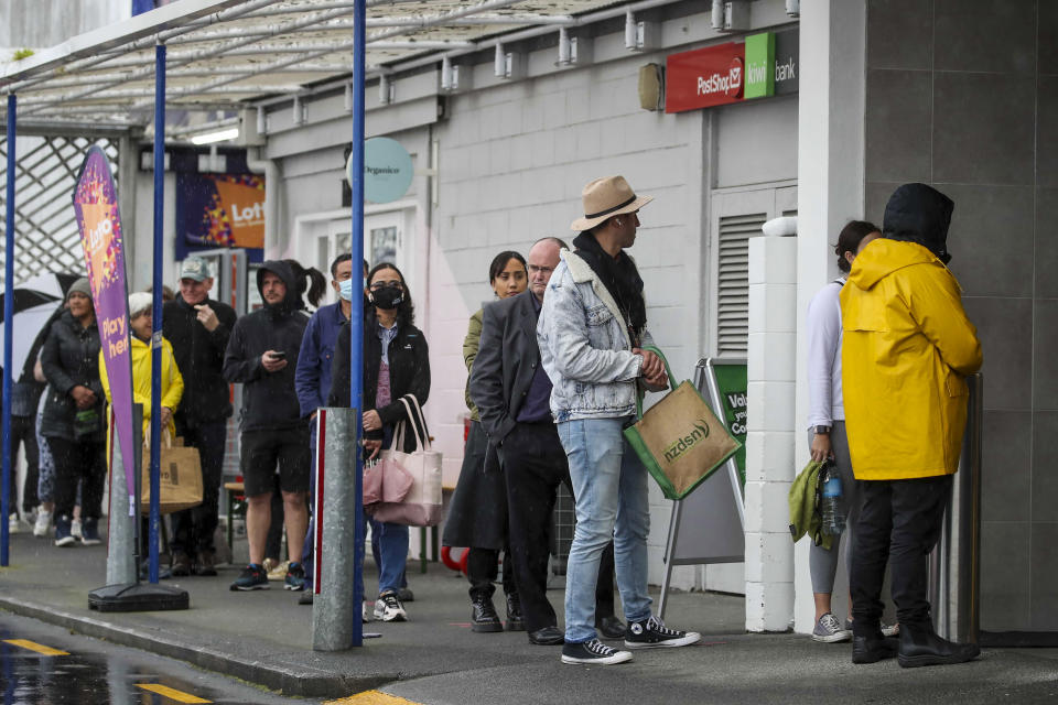 Shoppers lineup to enter a supermarket in Auckland, New Zealand, Tuesday, Aug. 17, 2021. New Zealand's government took drastic action Tuesday by putting the entire nation into a strict lockdown after detecting just a single community case of the coronavirus. (Jason Oxenham/New Zealand Herald via AP)