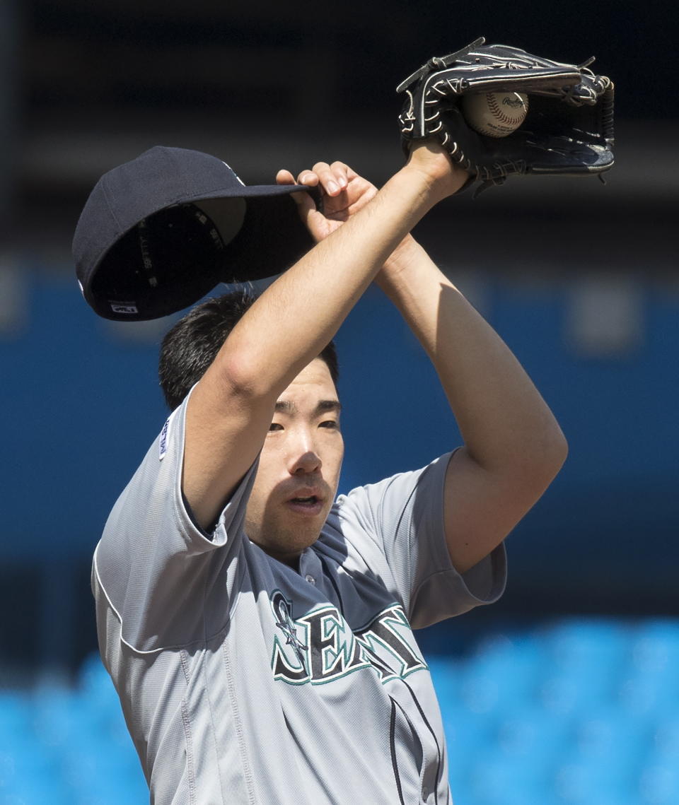 Seattle Mariners starting pitcher Yusei Kikuchi pauses before throwing to last Toronto Blue Jays hitter in the ninth inning of their baseball game in Toronto Sunday Aug. 18, 2019. Kikuchi pitched a complete game shutout to defeat the Blue Jays. (Fred Thornhill/The Canadian Press via AP)