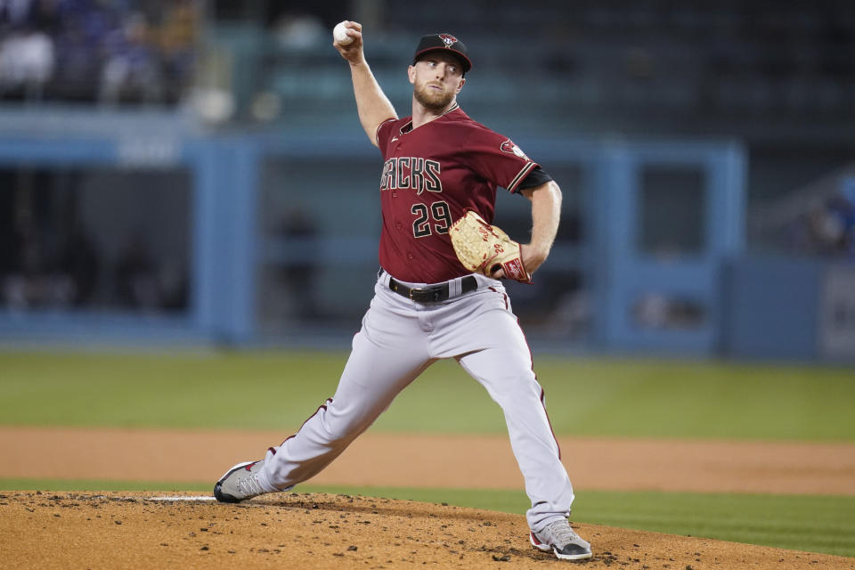 Arizona Diamondbacks starting pitcher Merrill Kelly (29) throws during the first inning of a baseball game against the Los Angeles Dodgers Wednesday, Sept. 15, 2021, in Los Angeles. (AP Photo/Ashley Landis)