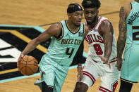 Charlotte Hornets guard Devonte' Graham (4) dribbles around Chicago Bulls forward Patrick Williams (9) during the first half of an NBA basketball game in Charlotte, N.C., Friday, Jan. 22, 2021. (AP Photo/Jacob Kupferman)