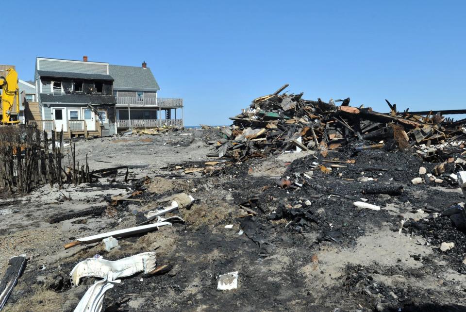 Rubble and ash are all that remain of five beachfront homes that were destroyed by a fire that also damaged three other houses on Glades Road in Scituate on Friday night.