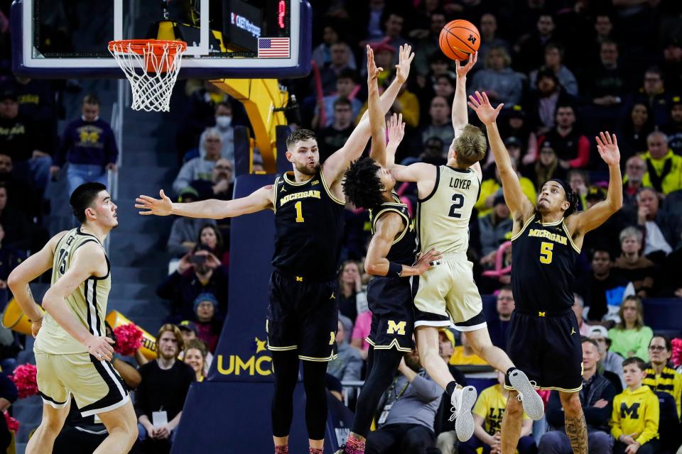 Purdue guard Fletcher Loyer (2) goes to the basket against Michigan center Hunter Dickinson (1), guard Kobe Bufkin (2) and guard Jaelin Llewellyn (3) during the first half at Crisler Center in Ann Arbor on Thursday, Jan. 26, 2023.
