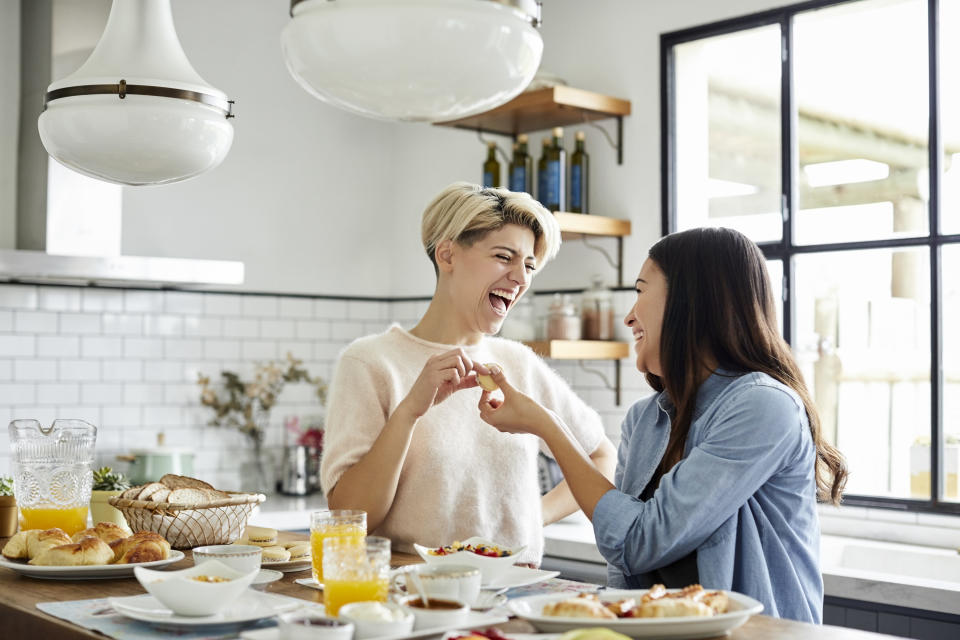 A couple laughing in their kitchen