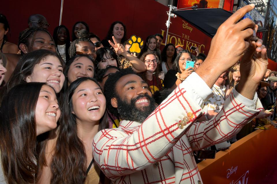 Donald Glover takes selfies with fans at the world premiere of 