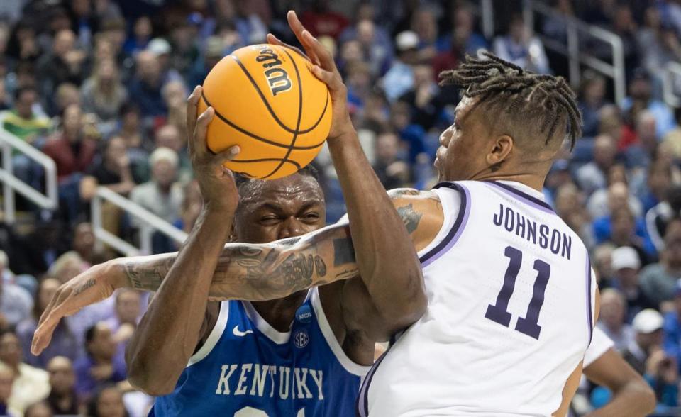 Kansas State’s Keyontae Johnson fouls Kentucky’s Oscar Tshiebwe during the first half of their second round NCAA Tournament game in Greensboro, NC on Sunday.