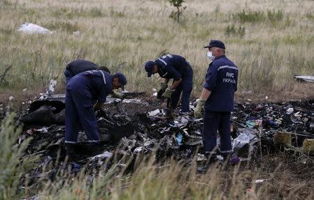 Members of the Ukrainian Emergencies Ministry work at a crash site of Malaysia Airlines Flight MH17, near the village of Hrabove, Donetsk region July 20, 2014. REUTERS/Maxim Zmeyev