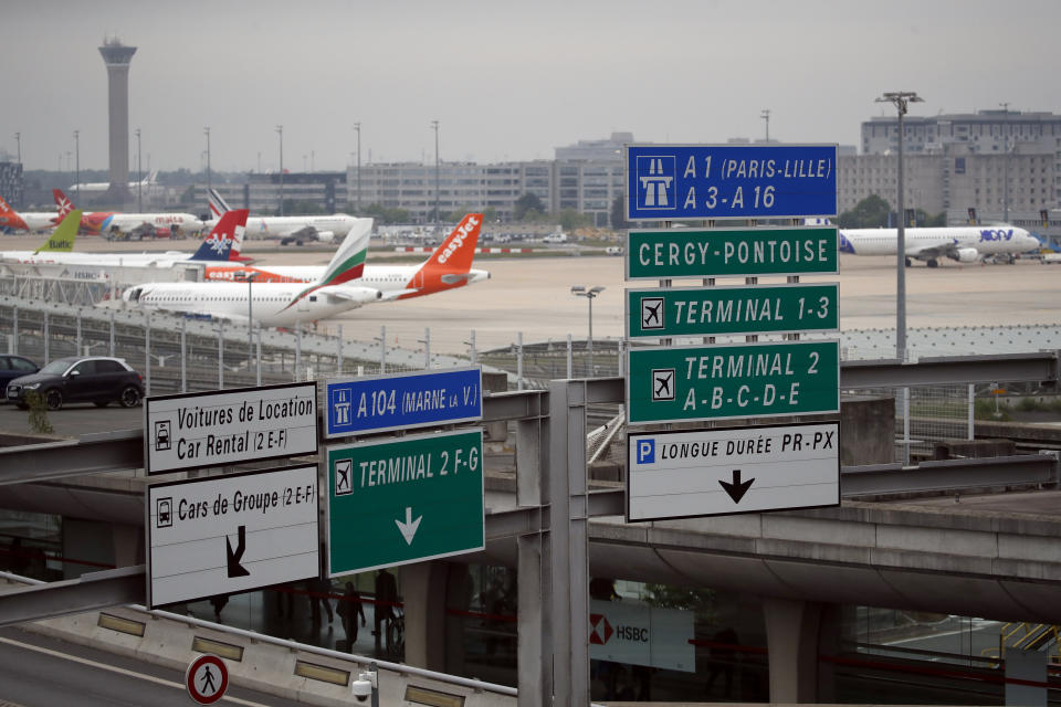 FILE - Planes are parked on the tarmac at Charles de Gaulle airport, in Roissy, near Paris, Friday, May 17, 2019. An express train that would whisk visitors from Paris' main international airport, Charles de Gaulle, to the city center in 20 minutes is not now slated to open before 2027. (AP Photo/Christophe Ena, File)