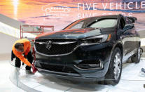 A worker details a 2018 Buick Avenir SUV on the display floor before the start of Press Days for the North American International Auto Show at Cobo Center in Detroit, Michigan, U.S., January 12, 2018. REUTERS/Rebecca Cook