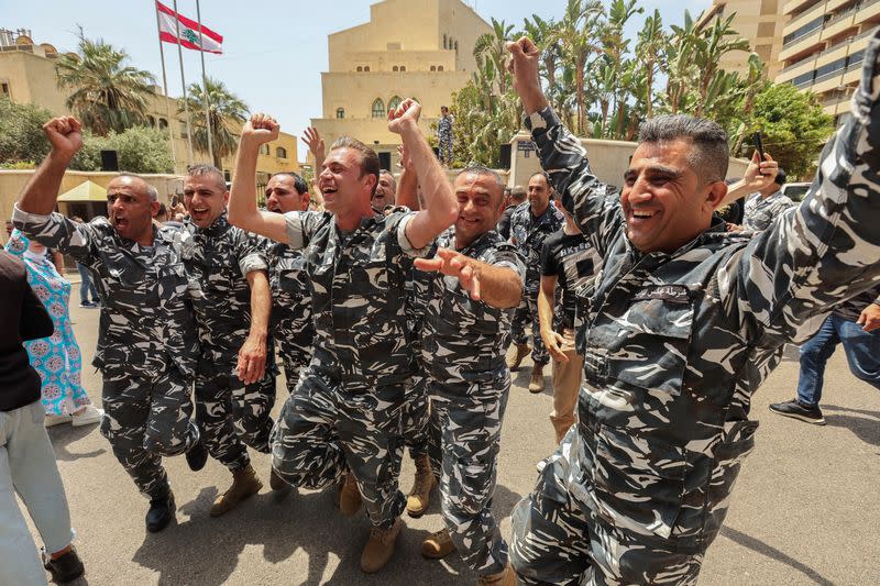 Members of Lebanese police gesture as they celebrate Nabih Berri's re-election as parliament speaker in Beirut