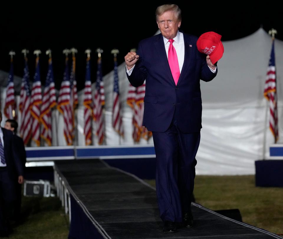 Former President Donald Trump acknowledges the crowd as he walks on stage during a campaign rally for Republican candidate for governor Tim Michels at the Waukesha County Fairgrounds in Waukesha August 5, 2022.