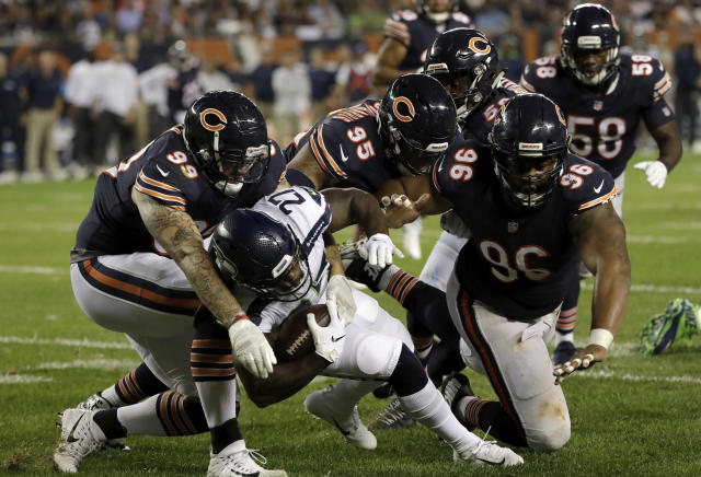 Seattle Seahawks running back Mike Davis (27) is tackled by a group of Bears defenders on Monday night. (AP)