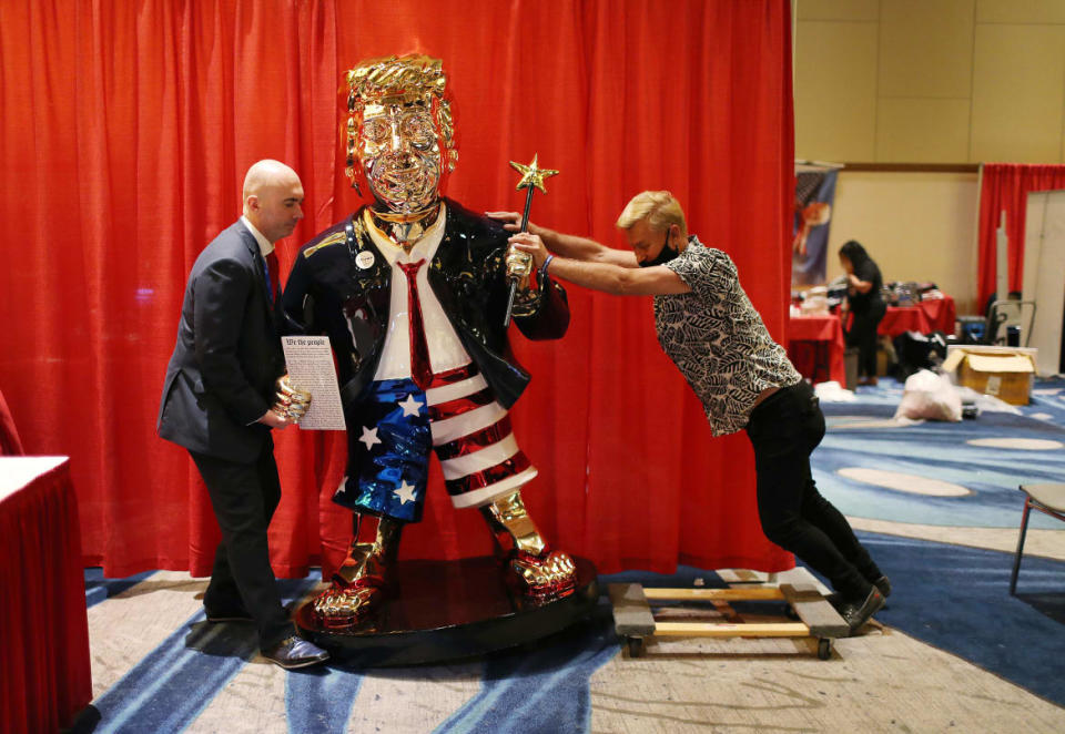 <div class="inline-image__caption"><p>Matt Braynard, left, helps artist Tommy Zegan move his statue of former President Donald Trump to a van during the Conservative Political Action Conference on February 27, 2021 in Orlando, Florida. </p></div> <div class="inline-image__credit">Joe Raedle/Getty</div>