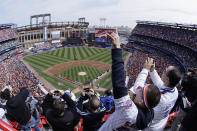 FILE - In this April 8, 2008, file photo, New York Mets fans look skyward for a fly-over at the end of the national anthem before an opening day baseball game against the Philadelphia Phillies at Shea Stadium in New York. To baseball fans, opening day is an annual rite of spring that evokes great anticipation and warm memories. This year's season was scheduled to begin Thursday, March 26, 2020, but there will be no games for a while because of the coronavirus outbreak. (AP Photo/Julie Jacobson, File)