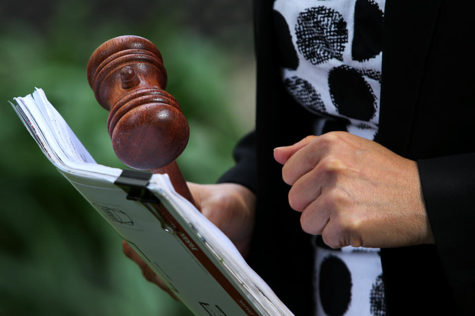 SYDNEY, AUSTRALIA - MAY 08: Auctioneer Karen Harvey holds a gavel during an auction of a residential property in Hurlstone Park on May 08, 2021 in Sydney, Australia. Property prices continue to rise across Australia with house prices up almost 27 percent compared to five years ago. Record low interest rates have also seen a surge in home loan applications in the last year. (Photo by Lisa Maree Williams/Getty Images)