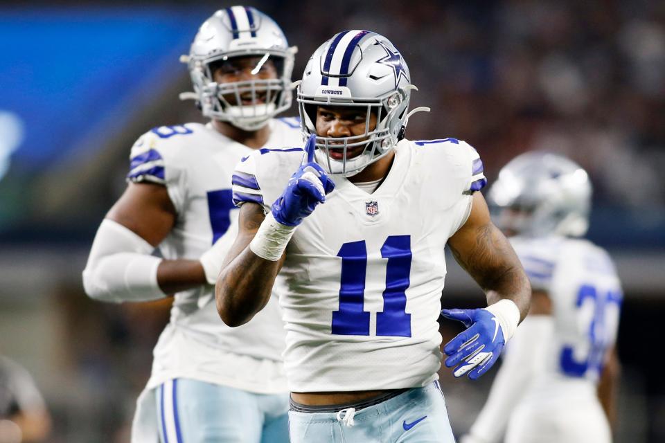 Dallas Cowboys outside linebacker Micah Parsons (11) celebrates a sack in the second quarter against the Washington Football Team at AT&T Stadium.