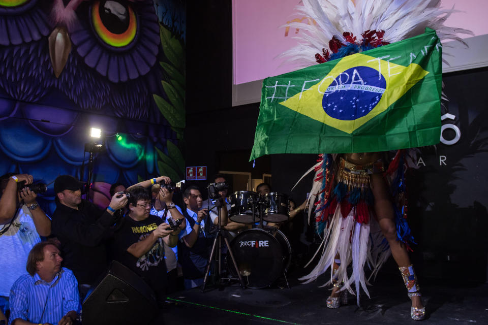 Rosie Oliveira from Amazonas holds a Brazilian national flag with an inscription reading 'Temer out' (a reference to Brazilian President Michel Temer) during the Miss Bumbum Brazil 2017 pageant in Sao Paulo. (Photo: NELSON ALMEIDA via Getty Images)